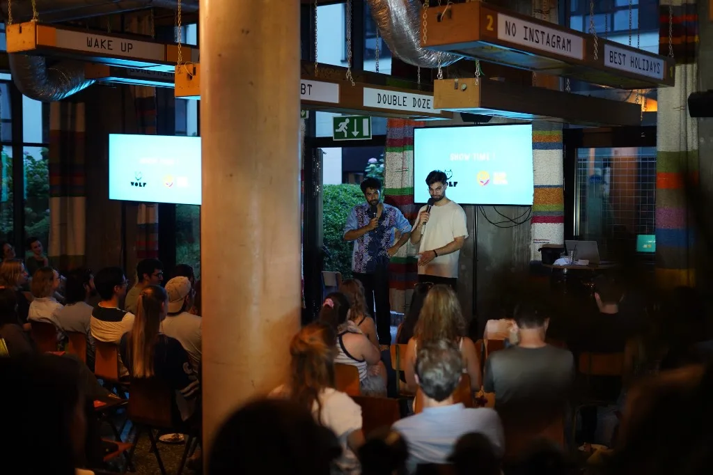 WOLF Sharing Food Market — comedians on stage with SHOW TIME screens
